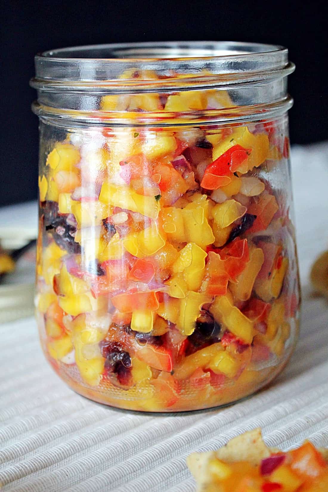 cranberry mango salsa in a mason jar.