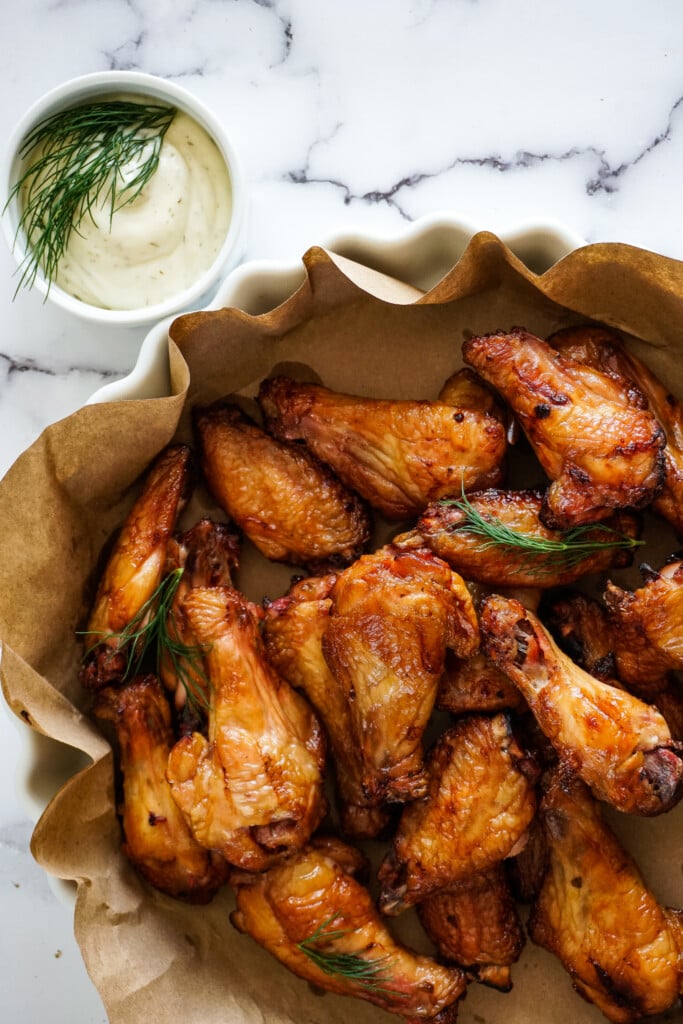 Dill pickle smoked chicken wings in a dish.