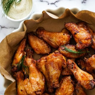 Dill pickle smoked chicken wings in a dish.