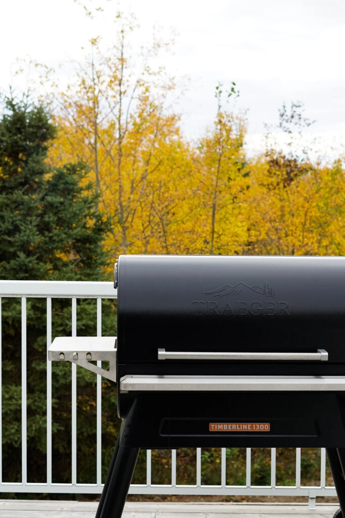 Traeger Timberline 1300 on a deck with fall leaves in the background.