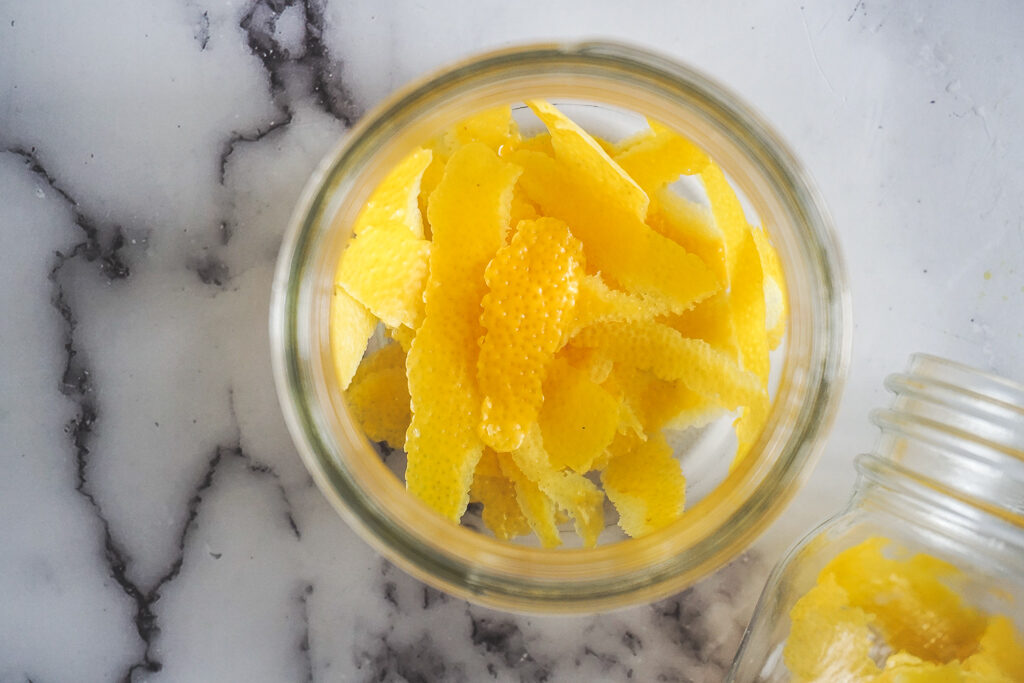 Looking down into a mason jar with lemon zest.