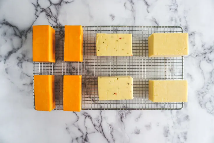 Smoked cheese on a wire mesh rack.
