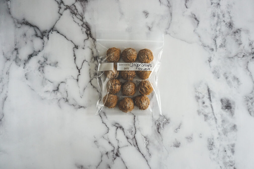12 frozen ginger snap cookie dough balls in a ziplock bag.