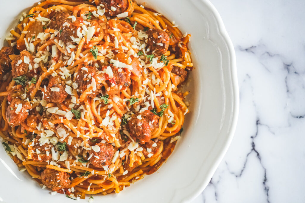 Instant pot spaghetti and meatballs in a white dish.