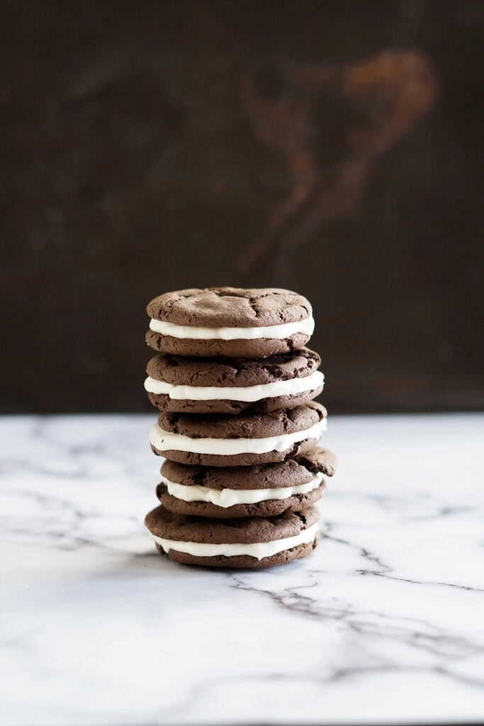 5 homemade oreos stacked in a pile.