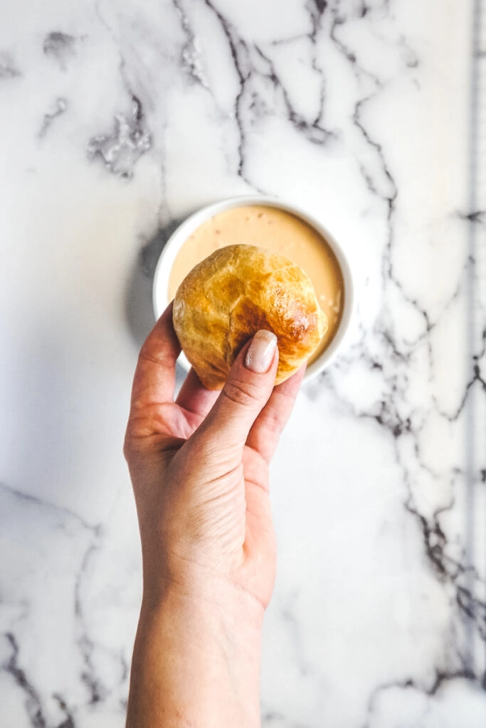 A hand holding a buffalo chicken bite.