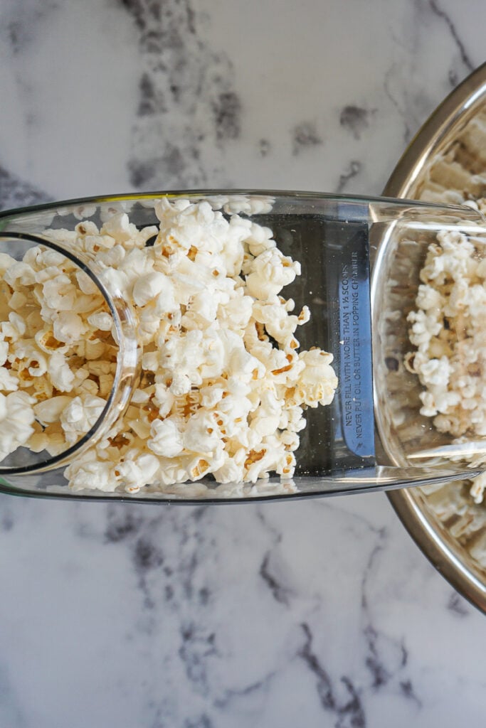 Popped popcorn rising up in an air popper. 