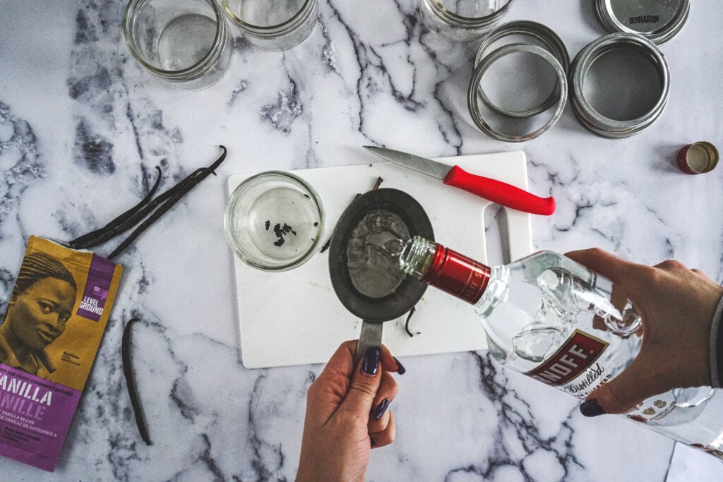 Pouring vodka into a measuring cup.