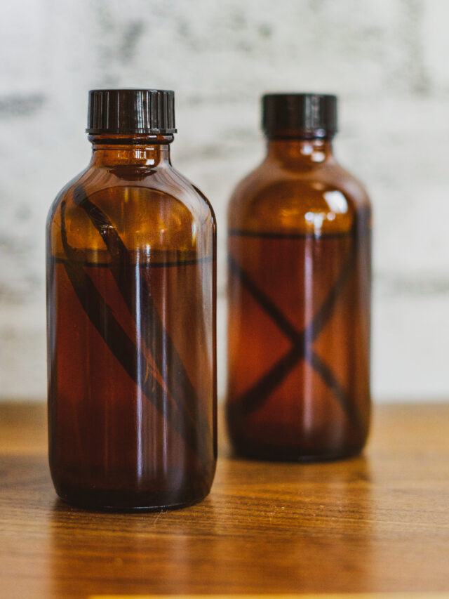 Sous vide vanilla extract with vanilla beans in the amber jar.