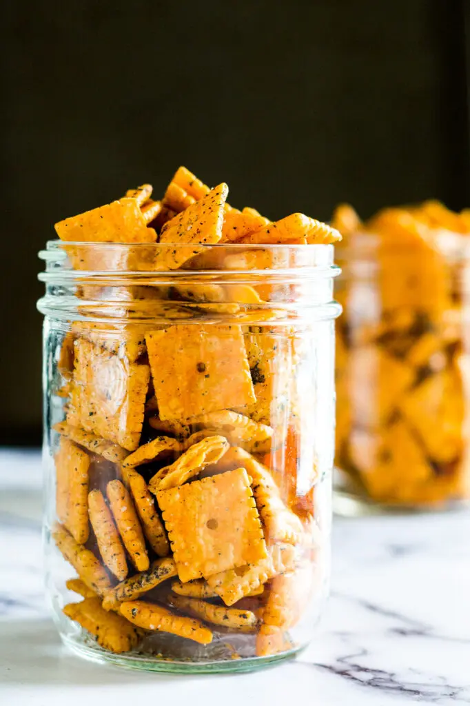 Two mason jars with smoked crackers in them.