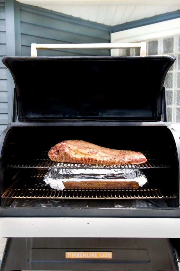 Wide open smoker filled with a massive brisket.