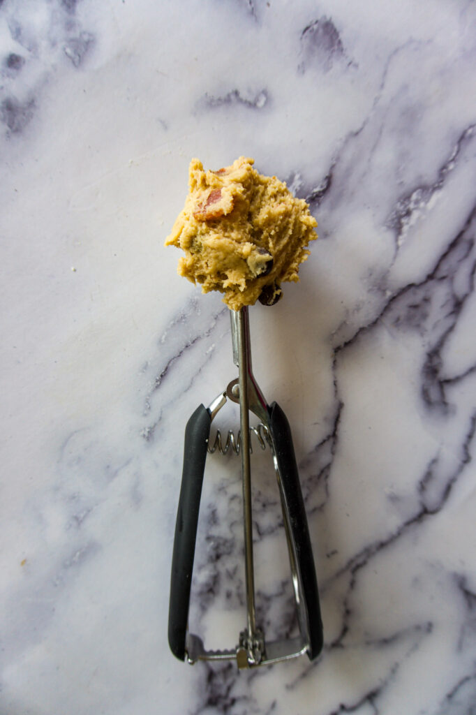 Cookie dough scoop full of dough.