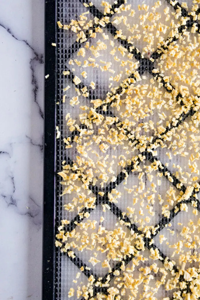 Dehydrated garlic on a dehydrator tray.