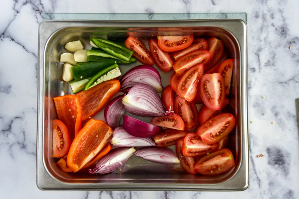Chopped veggies in a chafing pan.