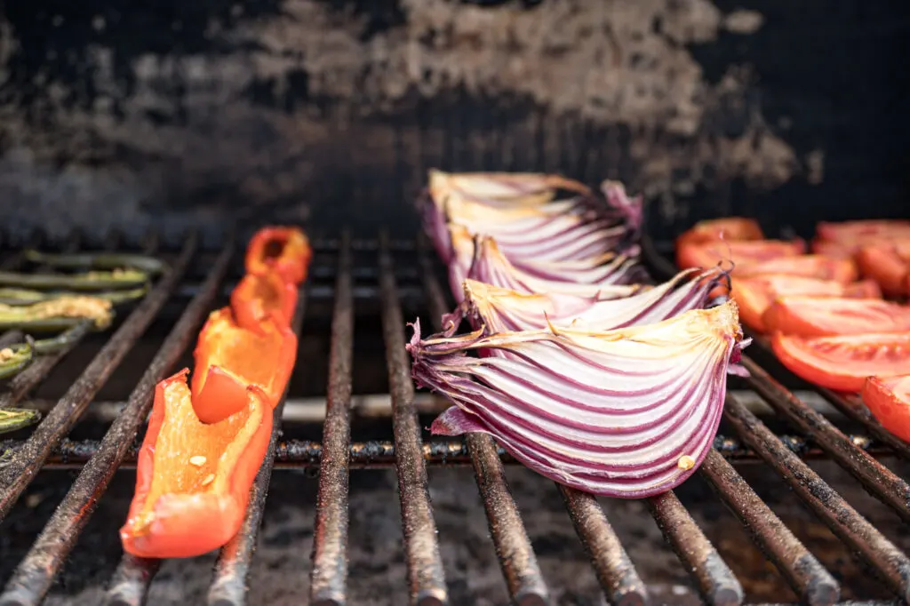 Slightly browned onions and peppers after being smoked.