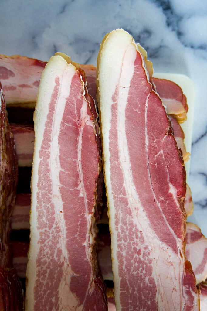 Two stacks of smoked bacon.