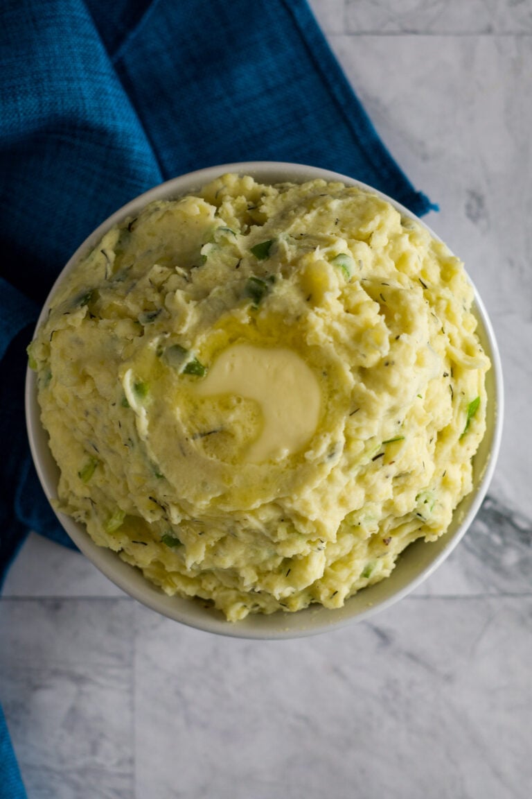 Overhead view of sous vide mashed potatoes in a white dish.