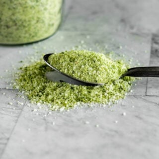 A spoon full of green tinged jalapeno salt.