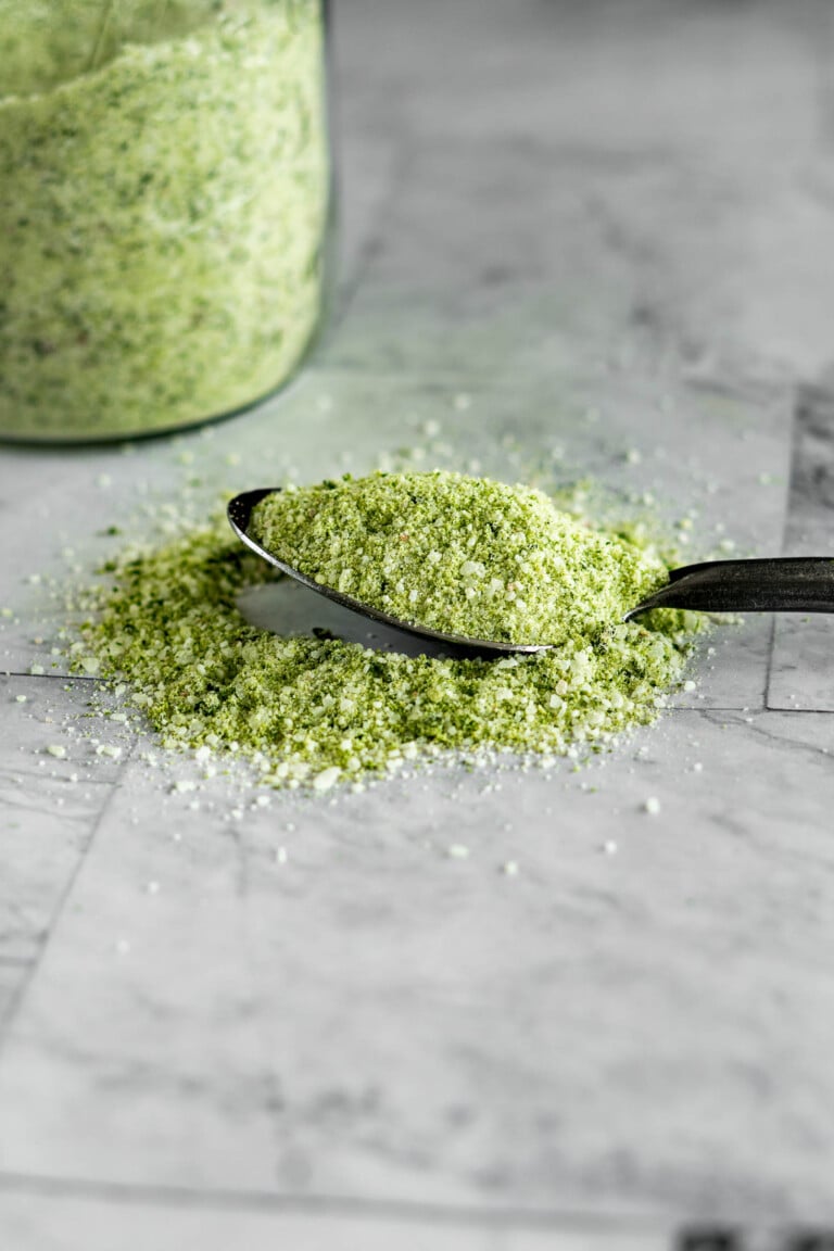 A spoon full of green tinged jalapeno salt.