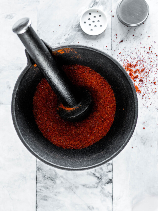 Sriracha powder in a mortar and pestle.
