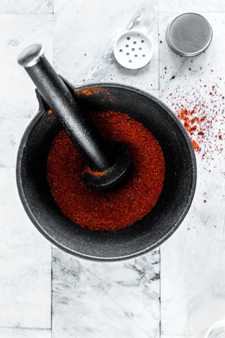 Sriracha powder in a mortar and pestle.
