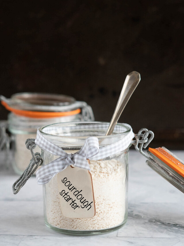 Sourdough starter in a mason jar with a spoon in it.