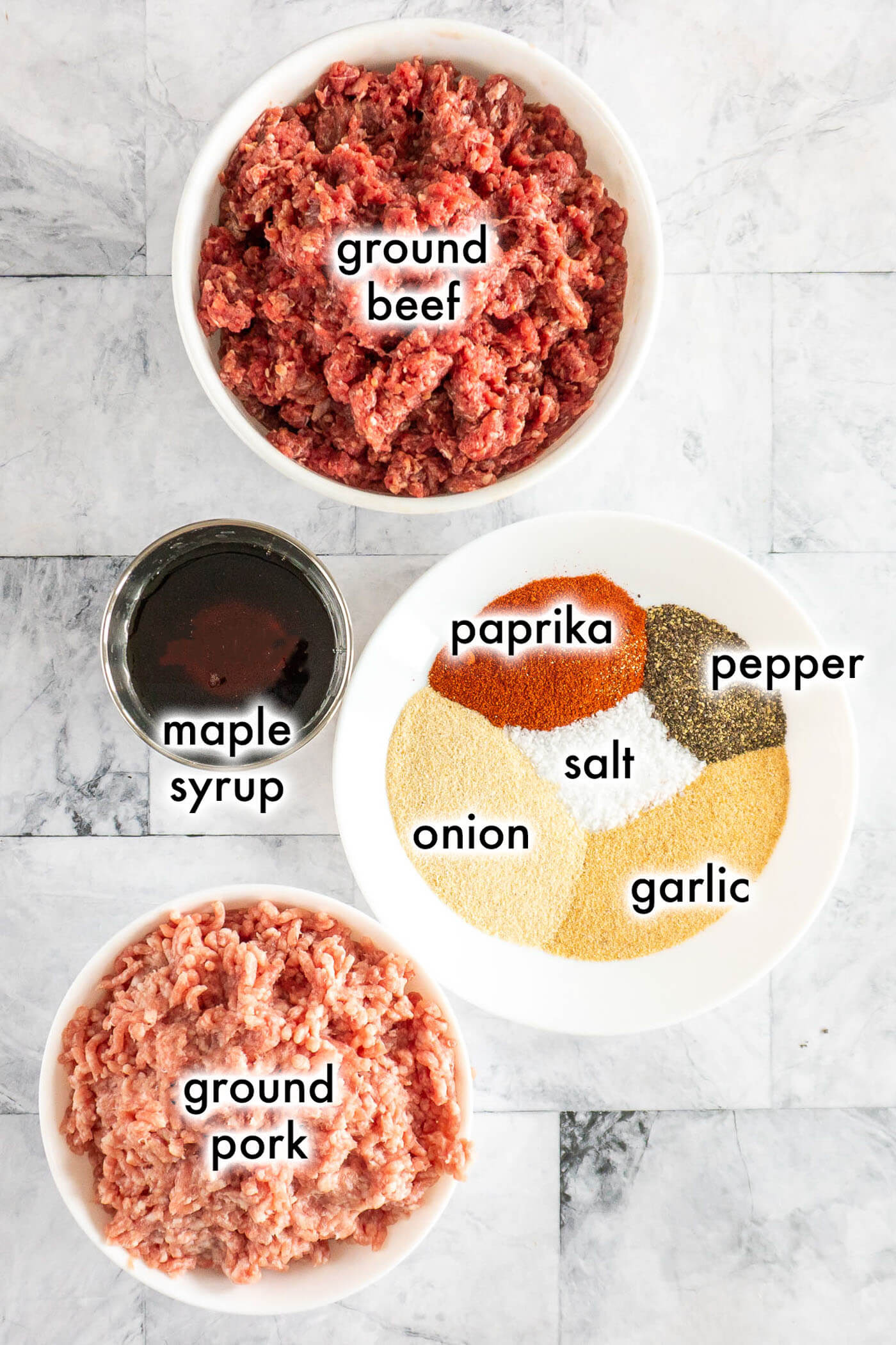 Prepped ingredients for beef jerky sticks on marble counter. 