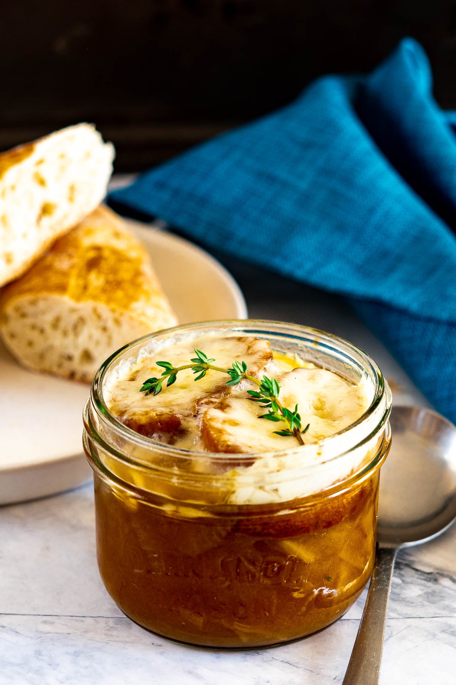 Smoked french onion soup in a mason jar.