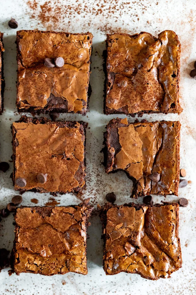 6 sourdough brownies lined up in rows with one missing a bite.