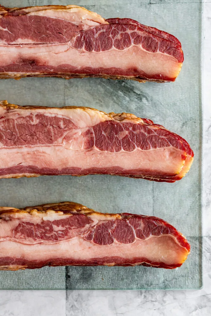Sliced beef bacon on a cutting board.