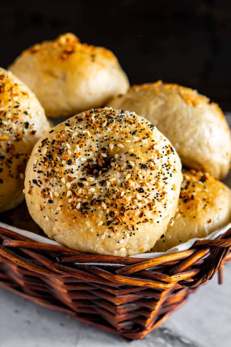Close up of sourdough bagels in a basket.