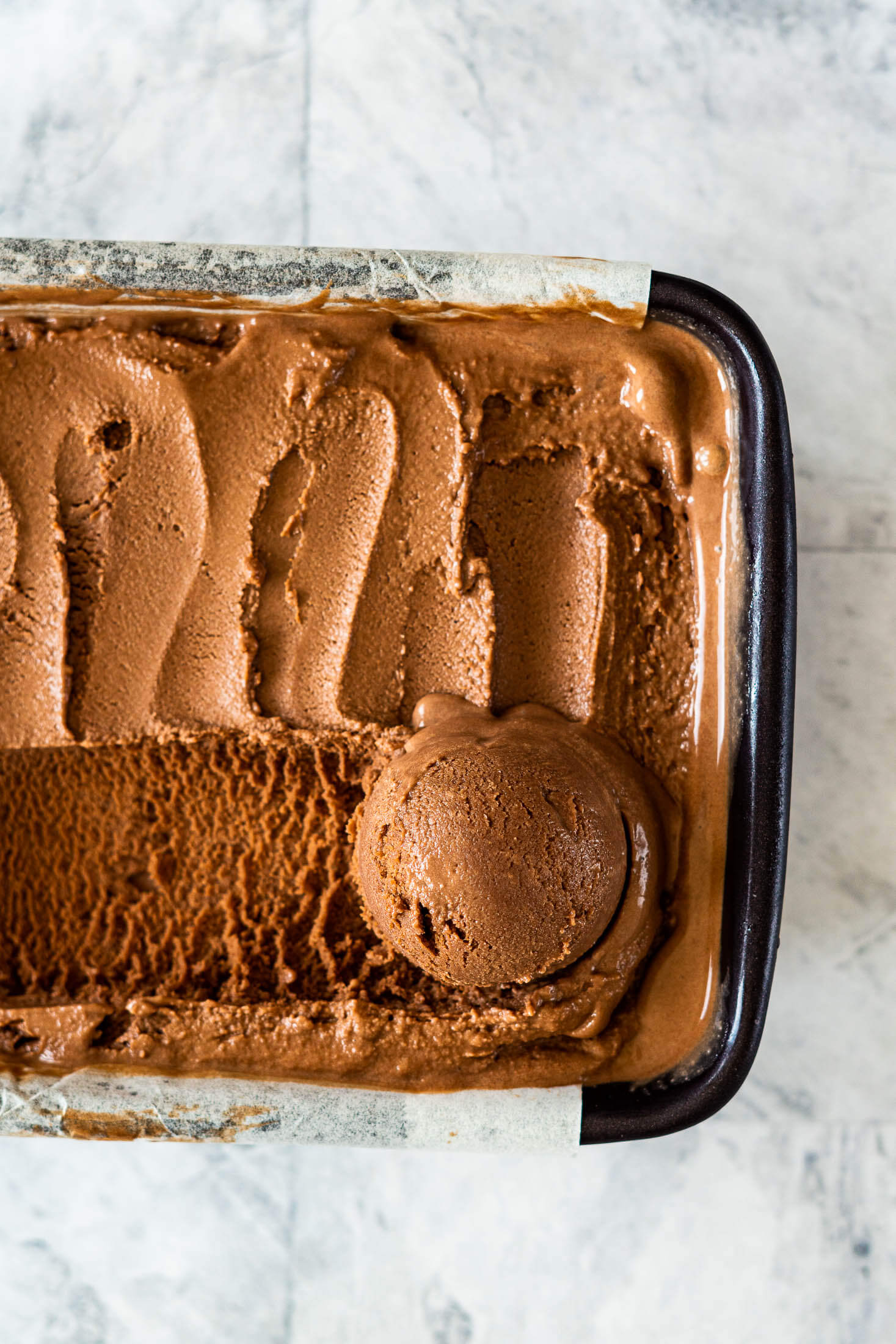 Chocolate sous vide ice cream with a scoop of ice cream on top.
