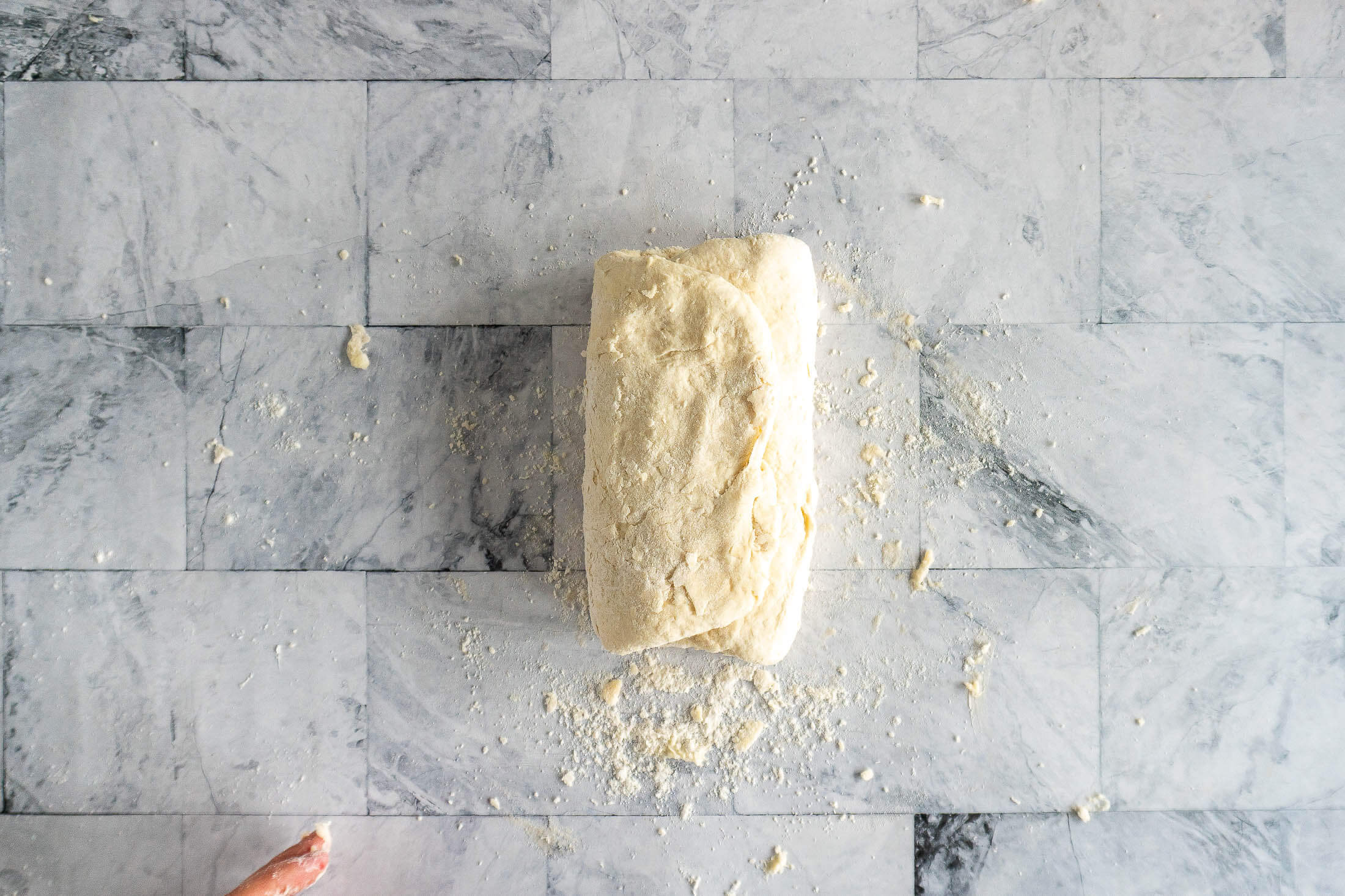 Folding the dough into an envelope shape.