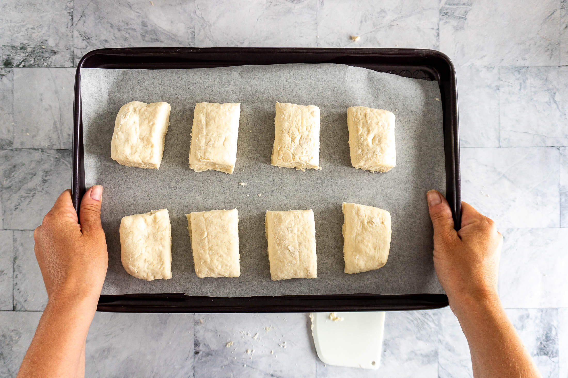 Homemade no milk biscuits on a parchment lined baking sheet.