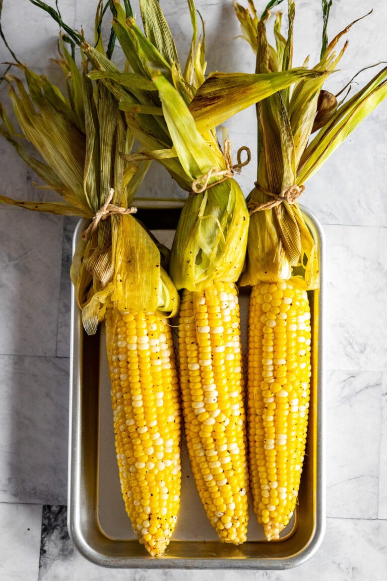 Open husks of smoked corn on the cob.