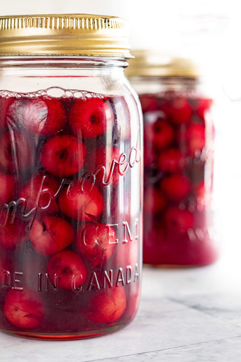Two jars of canned cherries.