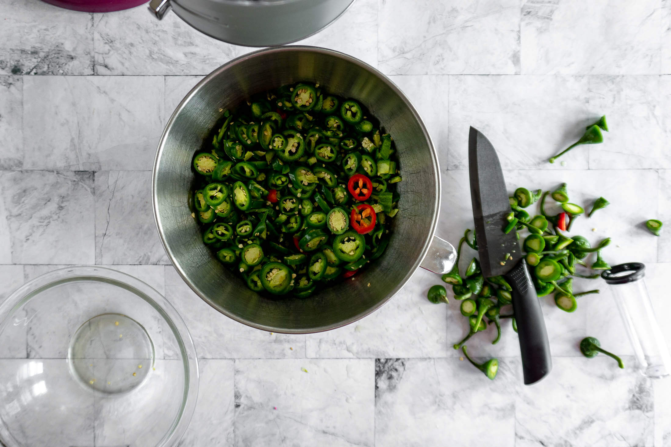 Bowl of jalapeño peppers sliced into even rings, ready for canning. 