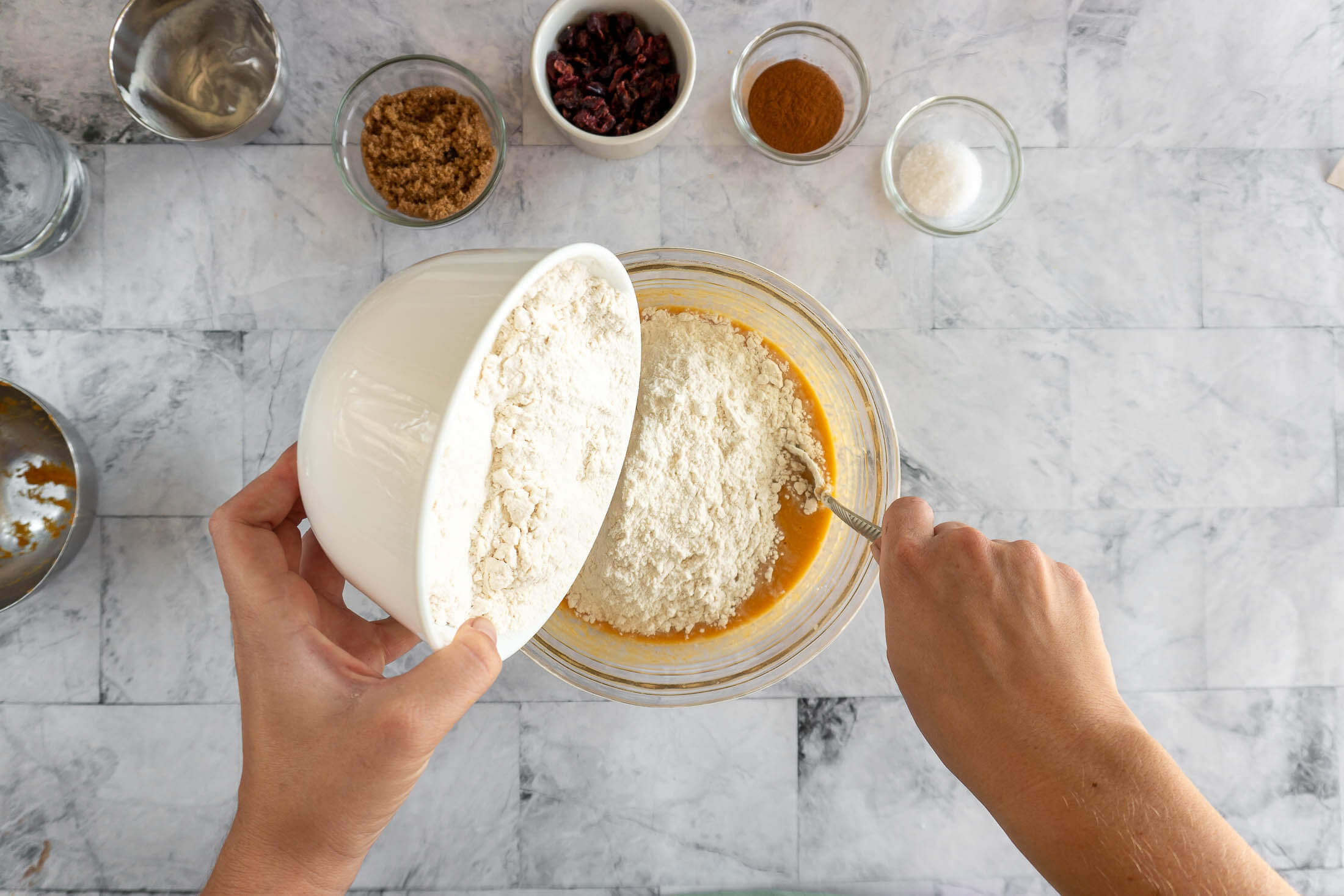 Mixing in the flour.