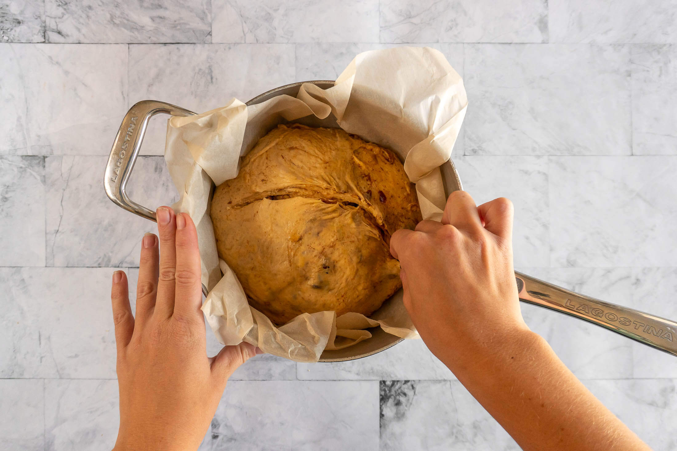 Scoring the pumpkin sourdough bread.