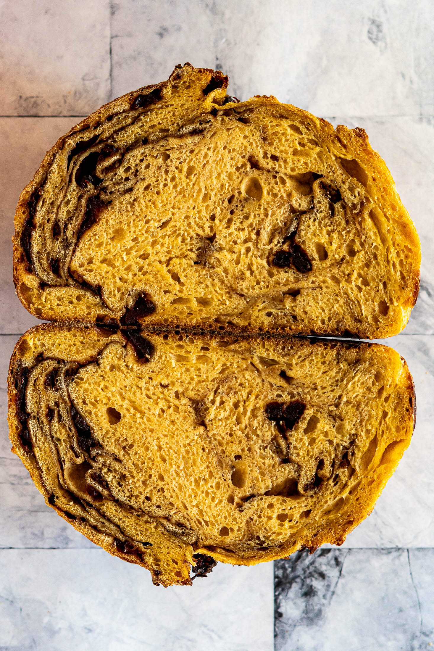 Two halves of a swirled pumpkin sourdough loaf.