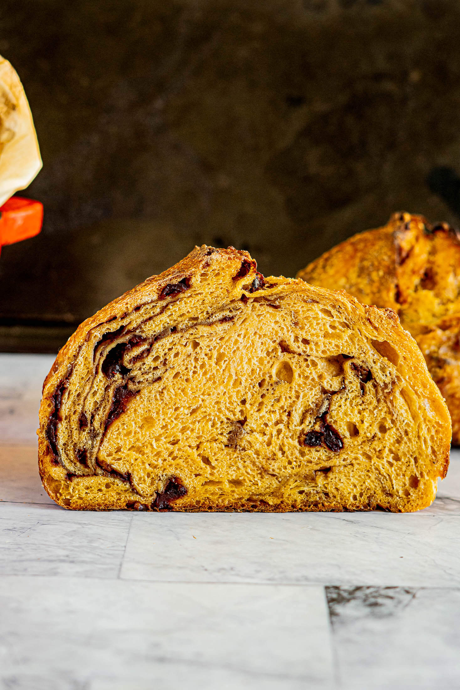 A sliced loaf of pumpkin sourdough bread.