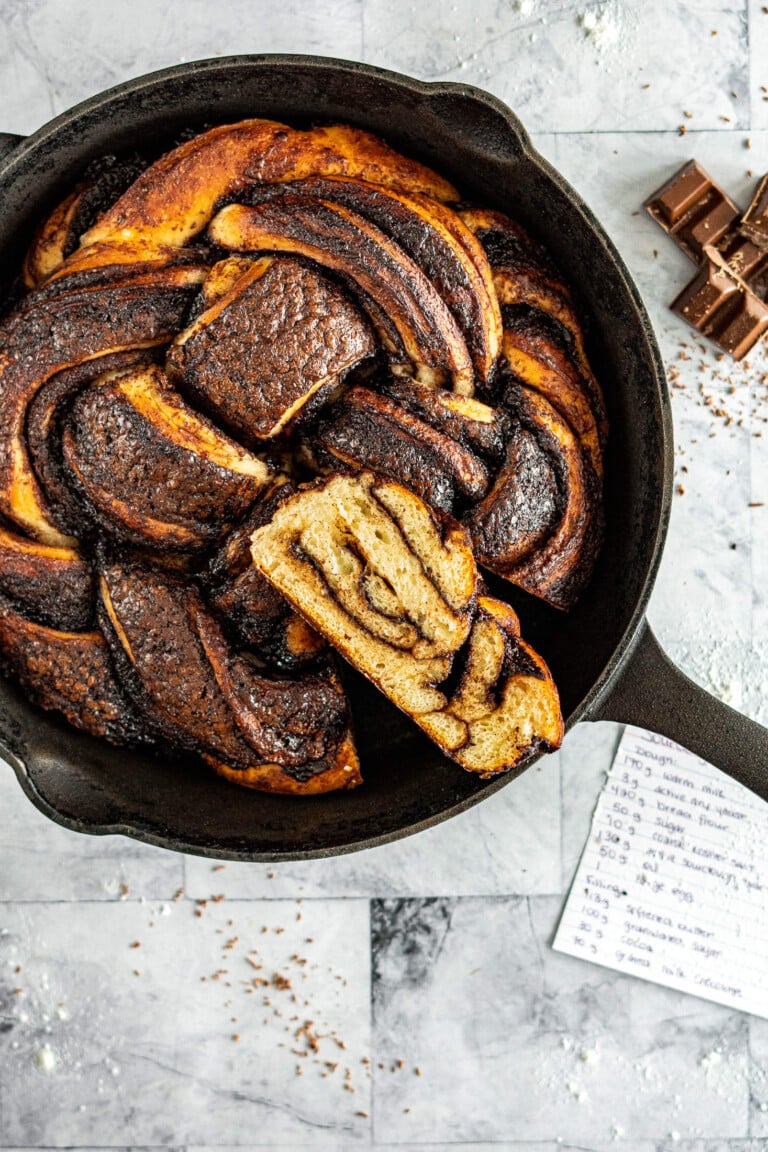 Baked sourdough chocolate babka in a cast iron skillet.