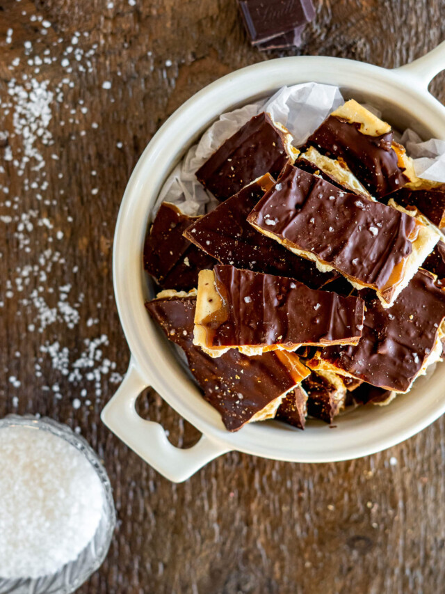 Overhead view of christmas cracker toffee in a white bowl.