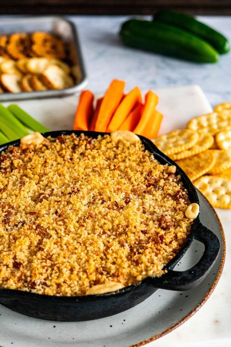 Cheese dripping down the side of a cast iron skillet.