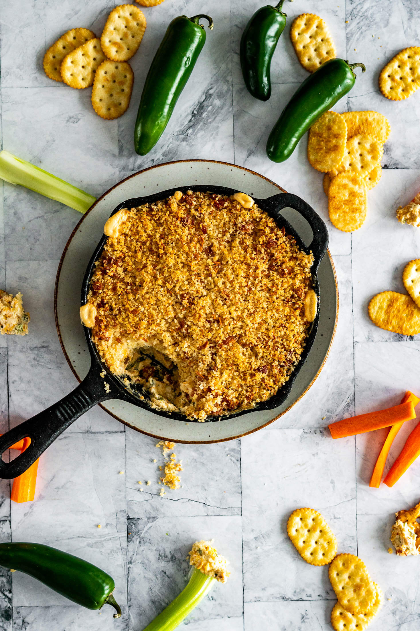 Jalapeno popper dip in a cast iron skillet.