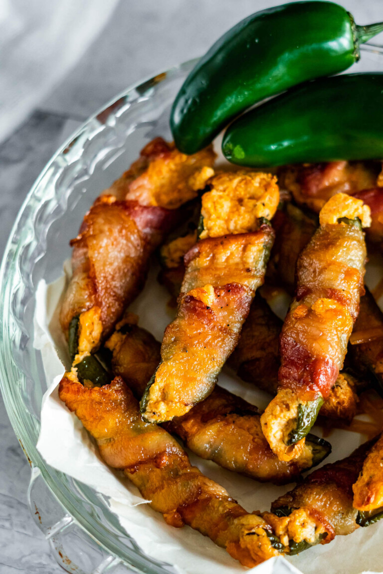 Smoked jalapeno poppers on a glass plate.