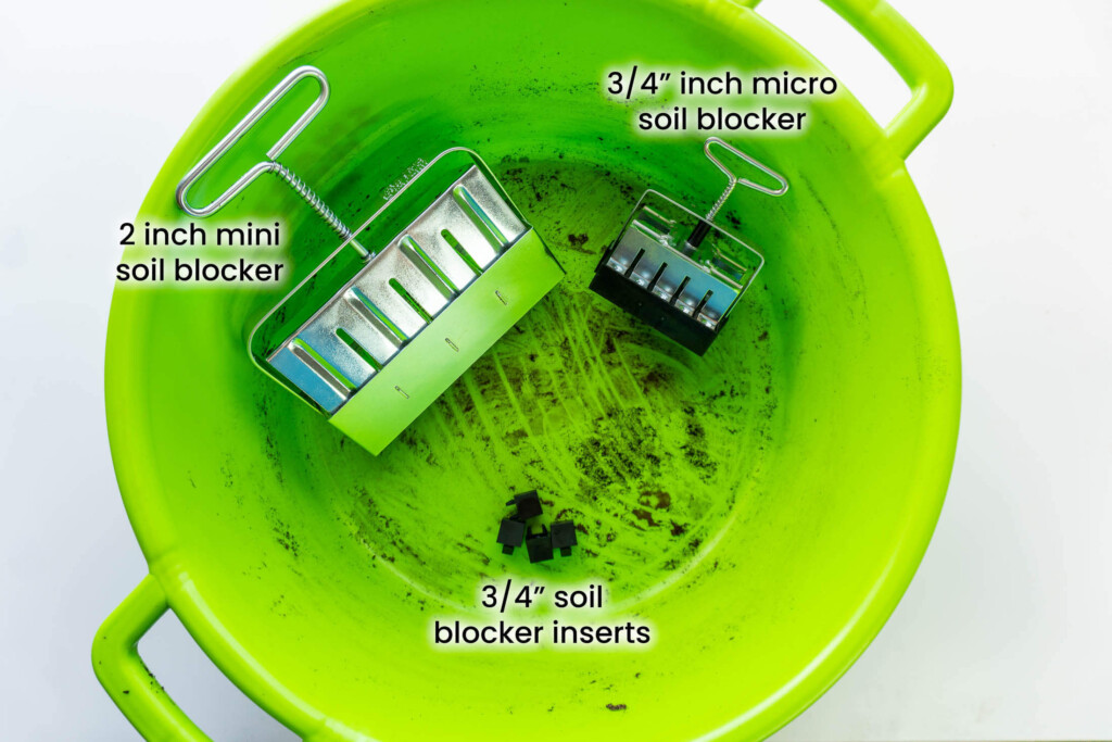 A mini and micro soil blocker in a green tub.
