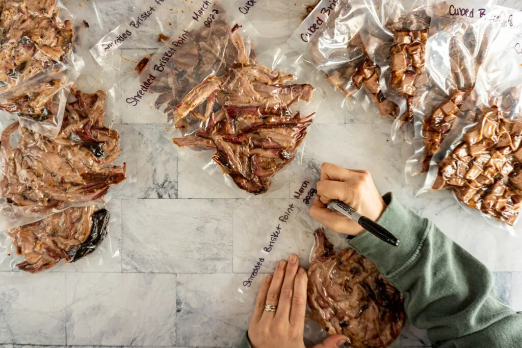 Labeling vacuum sealed shredded and slice brisket.