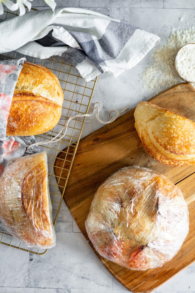 Sourdough loaves wrapped in plastic wrap.