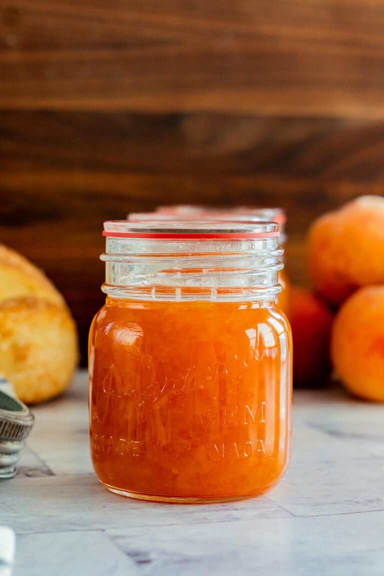 Homemade peach jam in a vintage jar.